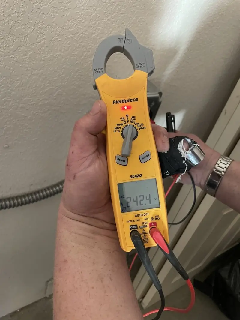 Voltage testing with clamp meter during Recessed Lighting Installation in Lincolnwood